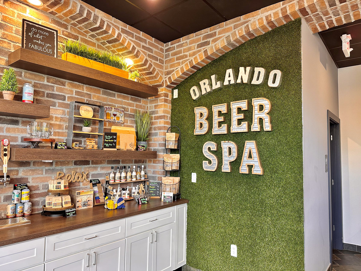 corner of beer spa with sign on a green wall and other products for sale